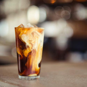 Homemade chocolate mint coffee frappe with rich foam texture and chocolate drizzle, perfect café style iced beverage