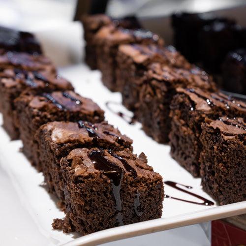 Chocolate chunk brownies recipe by oooflavors with fudgy texture and melted chocolate chunks on a baking tray