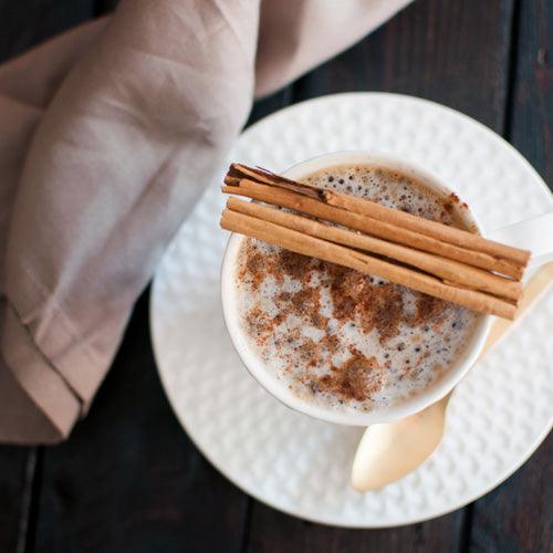 Creamy cinnamon keto coffee in a mug with frothy top, made with butter and MCT oil for energy and fat burning