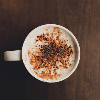 Creamy homemade toffee latte topped with whipped cream and caramel drizzle in a mug with rich espresso and milk foam.