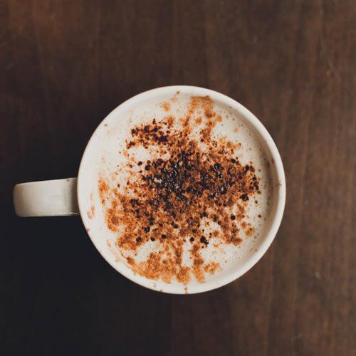 Creamy homemade toffee latte topped with whipped cream and caramel drizzle in a mug with rich espresso and milk foam.